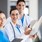 Smiling healthcare team holding clipboards