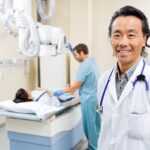 Smiling doctor in radiology room with patient