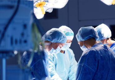 Surgeons performing surgery in operating room