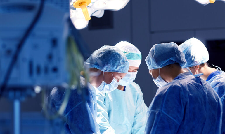 Surgeons performing surgery in operating room
